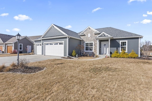 ranch-style house featuring a front lawn, concrete driveway, roof with shingles, stone siding, and an attached garage