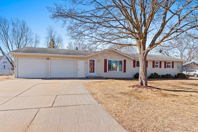 ranch-style house featuring a garage and driveway