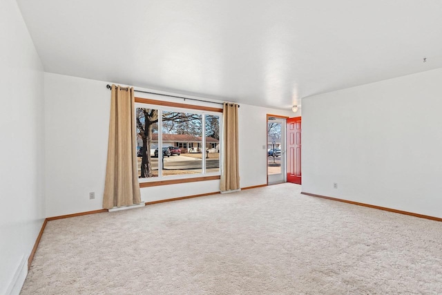 empty room with light colored carpet and baseboards