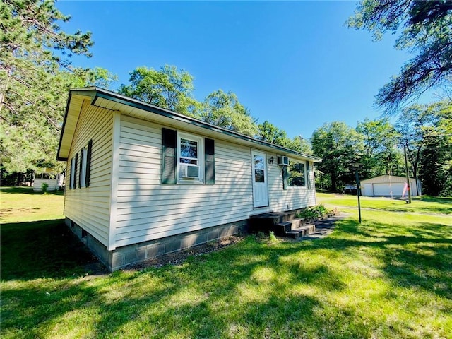 exterior space with entry steps and a front yard