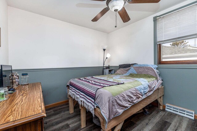 bedroom featuring a ceiling fan, wood finished floors, visible vents, and baseboards