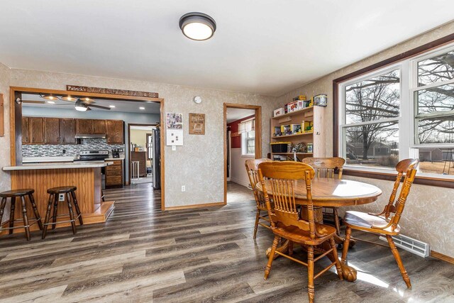 dining room featuring baseboards and dark wood-style flooring