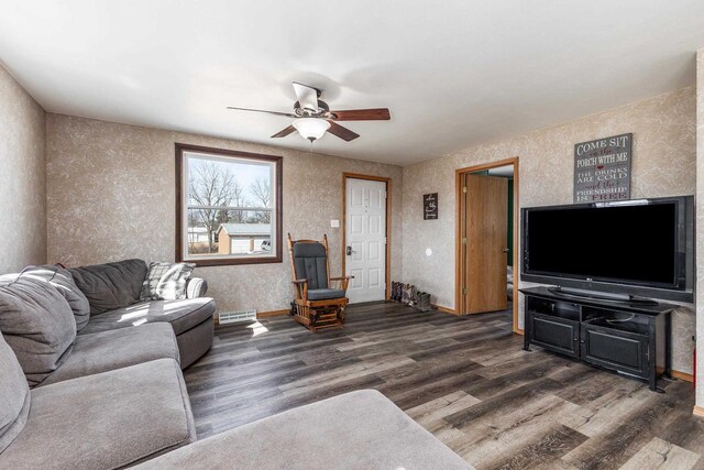 living area with ceiling fan, visible vents, baseboards, and wood finished floors