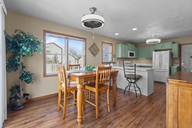 dining area with recessed lighting and dark wood-style floors