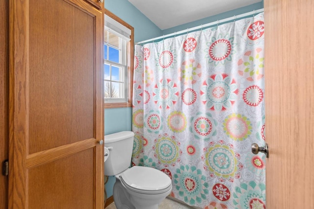 full bath with a shower with curtain and toilet