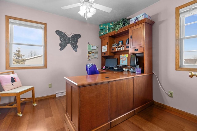 home office featuring visible vents, wood finished floors, baseboards, and ceiling fan