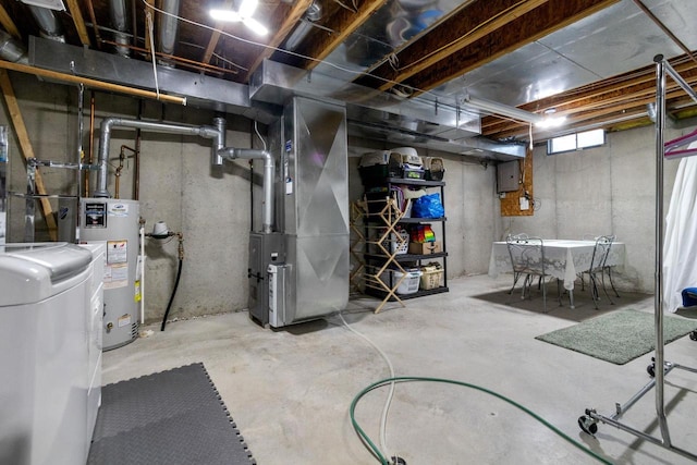 basement featuring washer / dryer, heating unit, and water heater