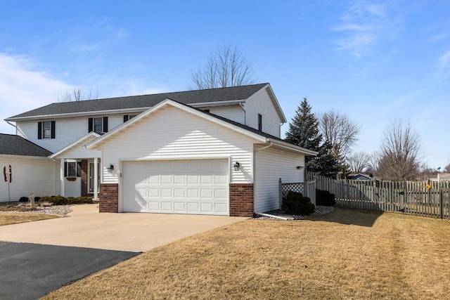 traditional home with a garage, fence, brick siding, and driveway