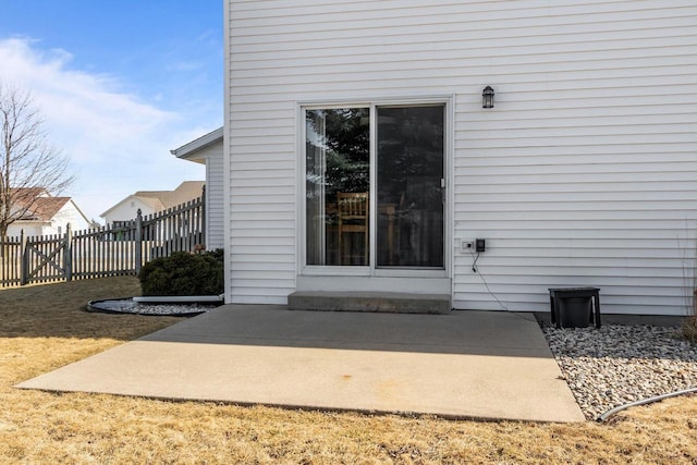 doorway to property featuring a patio and fence