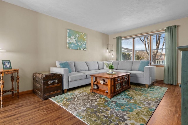 living area with baseboards and wood finished floors