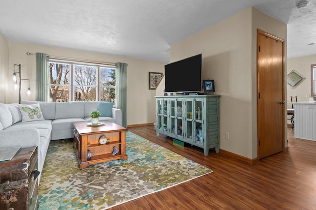 living room featuring baseboards and wood finished floors