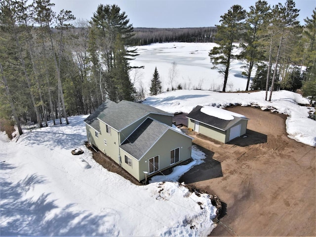 snowy aerial view with a view of trees