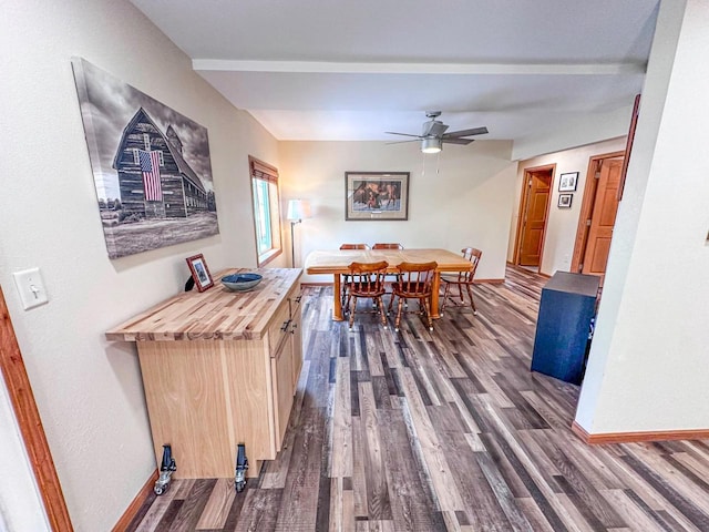 dining space featuring dark wood-type flooring, baseboards, and ceiling fan