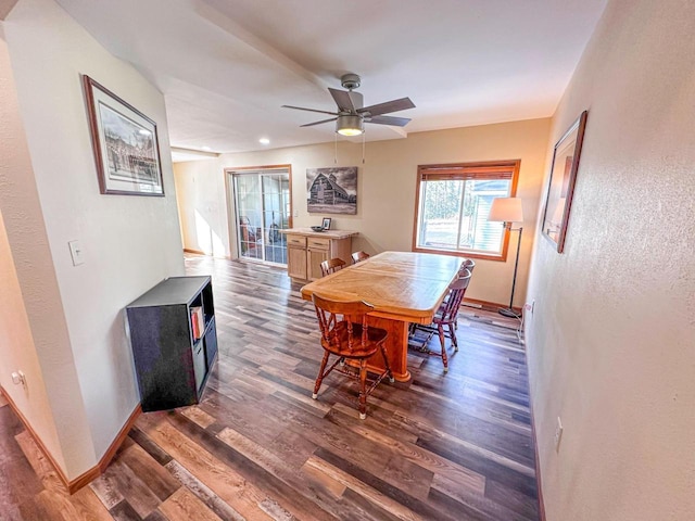 dining room featuring baseboards, wood finished floors, and a ceiling fan