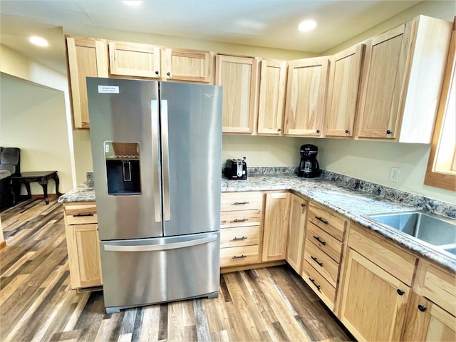 kitchen featuring recessed lighting, light brown cabinets, wood finished floors, and stainless steel refrigerator with ice dispenser