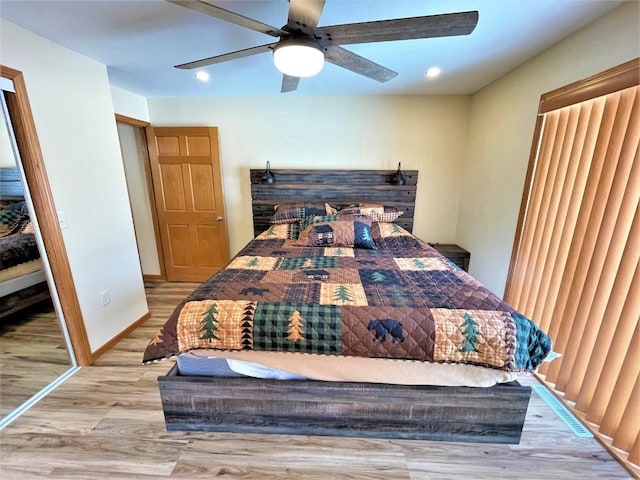 bedroom featuring recessed lighting, baseboards, wood finished floors, and a ceiling fan