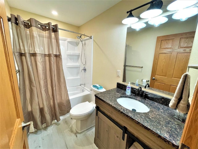 bathroom featuring toilet, vanity, and shower / bath combination with curtain