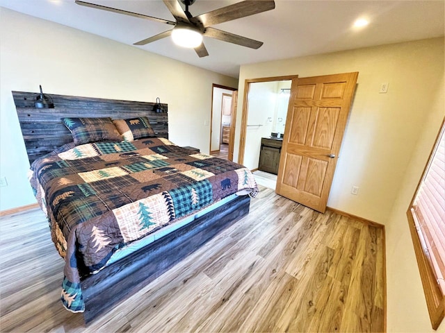 bedroom with ensuite bath, light wood-style floors, baseboards, and ceiling fan