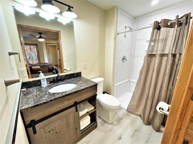 full bathroom with toilet, vanity, a shower with curtain, and wood finished floors