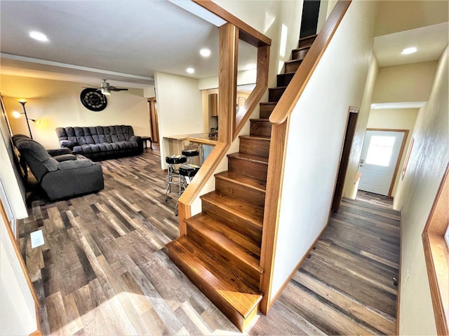 stairs with recessed lighting, wood finished floors, and a ceiling fan