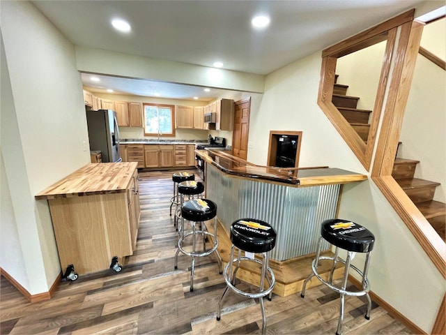 bar featuring stairway, recessed lighting, dark wood-style floors, stainless steel appliances, and a sink