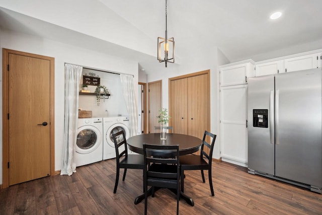 dining area featuring dark wood finished floors, washing machine and dryer, and lofted ceiling