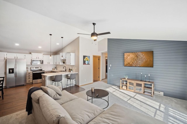 living area featuring recessed lighting, high vaulted ceiling, wood finished floors, and a ceiling fan