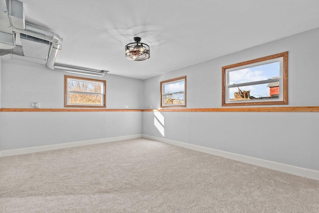 spare room featuring baseboards and carpet floors