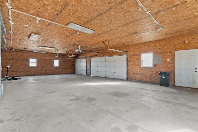 garage featuring electric panel and a garage door opener