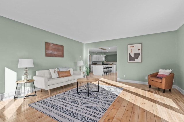 living room featuring light wood finished floors and baseboards