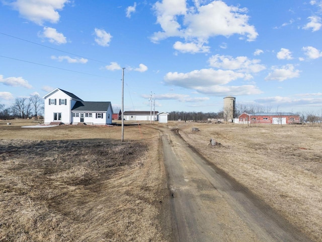 view of road featuring dirt driveway