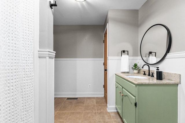 bathroom with tile patterned floors, visible vents, vanity, and wainscoting