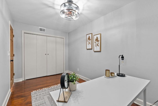 office area featuring visible vents, baseboards, a notable chandelier, and wood finished floors