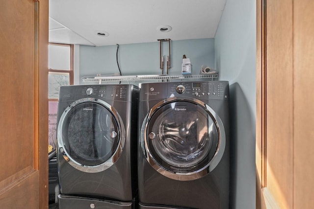 clothes washing area with laundry area and washing machine and clothes dryer