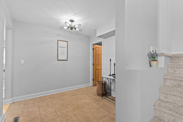 corridor with visible vents, baseboards, stairway, tile patterned floors, and a notable chandelier