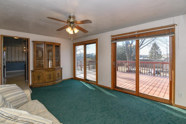 unfurnished living room with baseboards, plenty of natural light, and carpet flooring