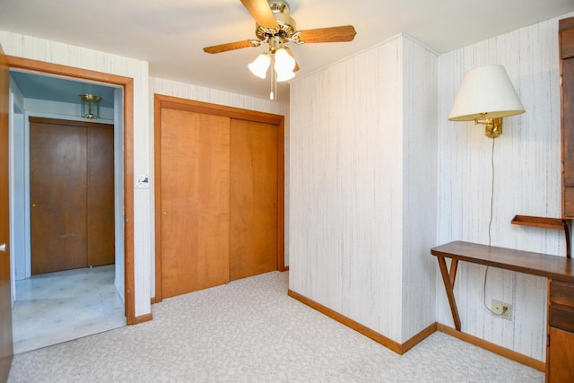 unfurnished bedroom featuring carpet flooring and a ceiling fan