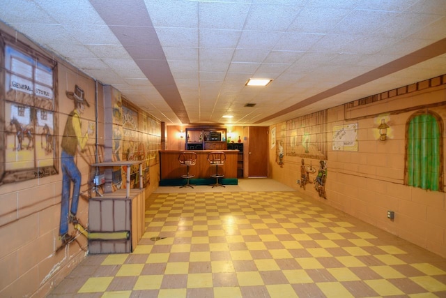 finished basement with concrete block wall and light floors