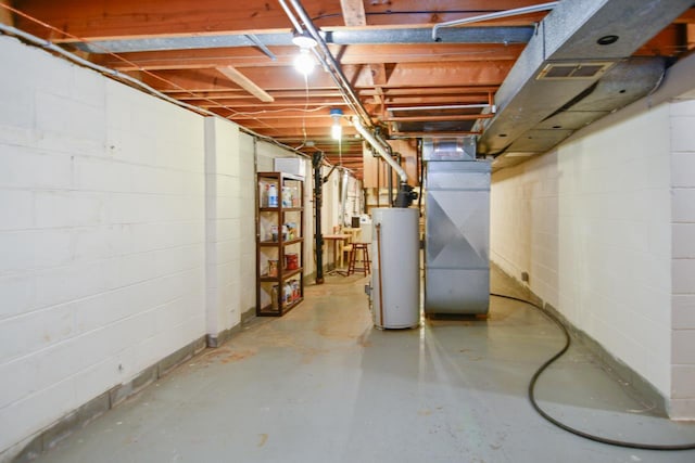 unfinished below grade area featuring gas water heater, heating unit, and visible vents