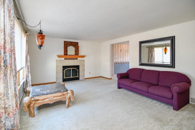 living room featuring visible vents, baseboards, carpet, and a fireplace