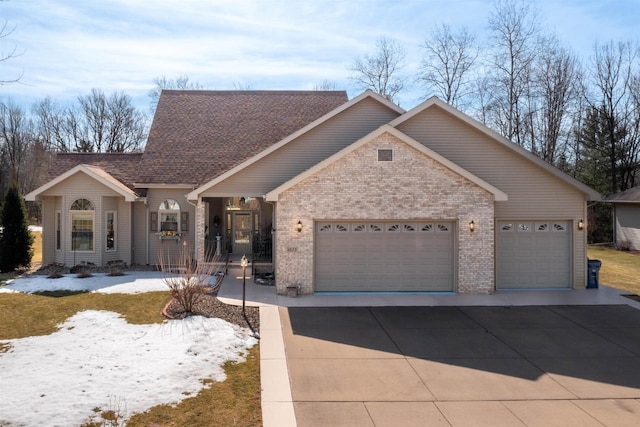 view of front facade with brick siding, concrete driveway, a garage, and a shingled roof