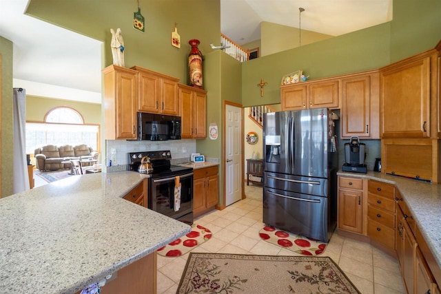 kitchen with high vaulted ceiling, black appliances, a peninsula, light tile patterned floors, and decorative backsplash