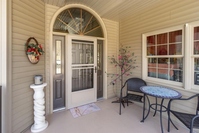 view of exterior entry with covered porch