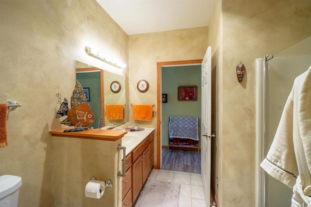 full bath with tile patterned floors, an enclosed shower, toilet, and vanity