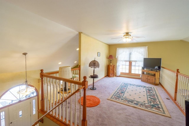 interior space featuring baseboards, carpet floors, lofted ceiling, and ceiling fan