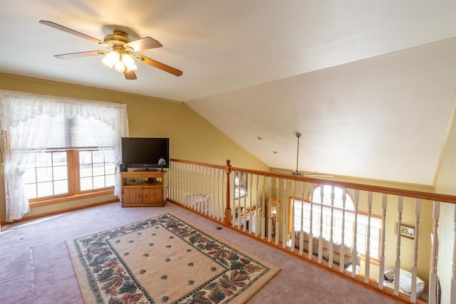 sitting room featuring lofted ceiling, carpet, and a ceiling fan