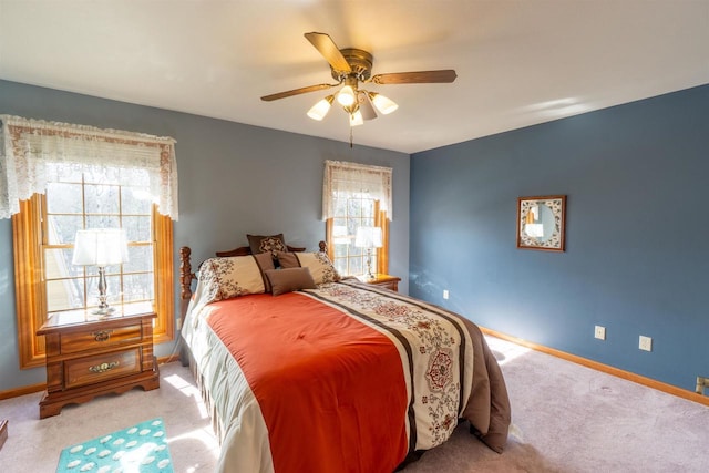 bedroom with a ceiling fan, baseboards, and carpet floors