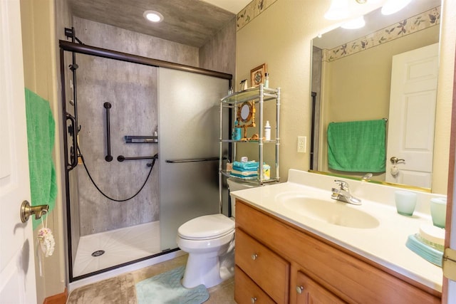 full bathroom featuring vanity, a shower stall, and toilet