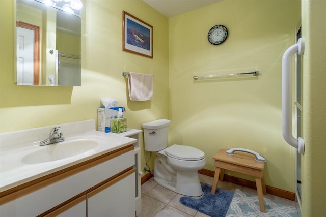 bathroom with tile patterned flooring, toilet, vanity, and baseboards