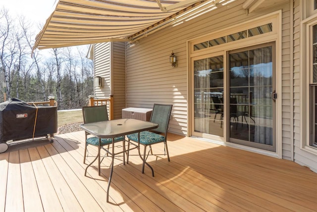 wooden terrace with outdoor dining space